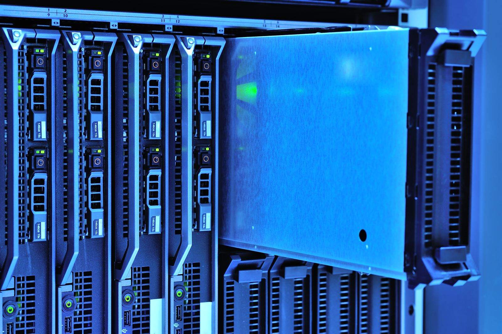 Rows of rack-mounted servers with blue status lights in a data centre
